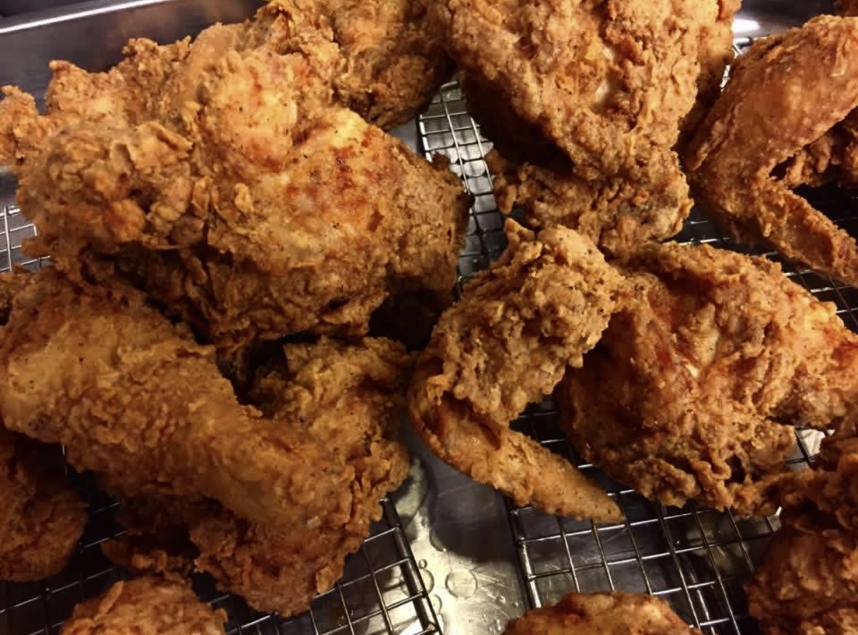 Golden fried chicken fresh off the rack